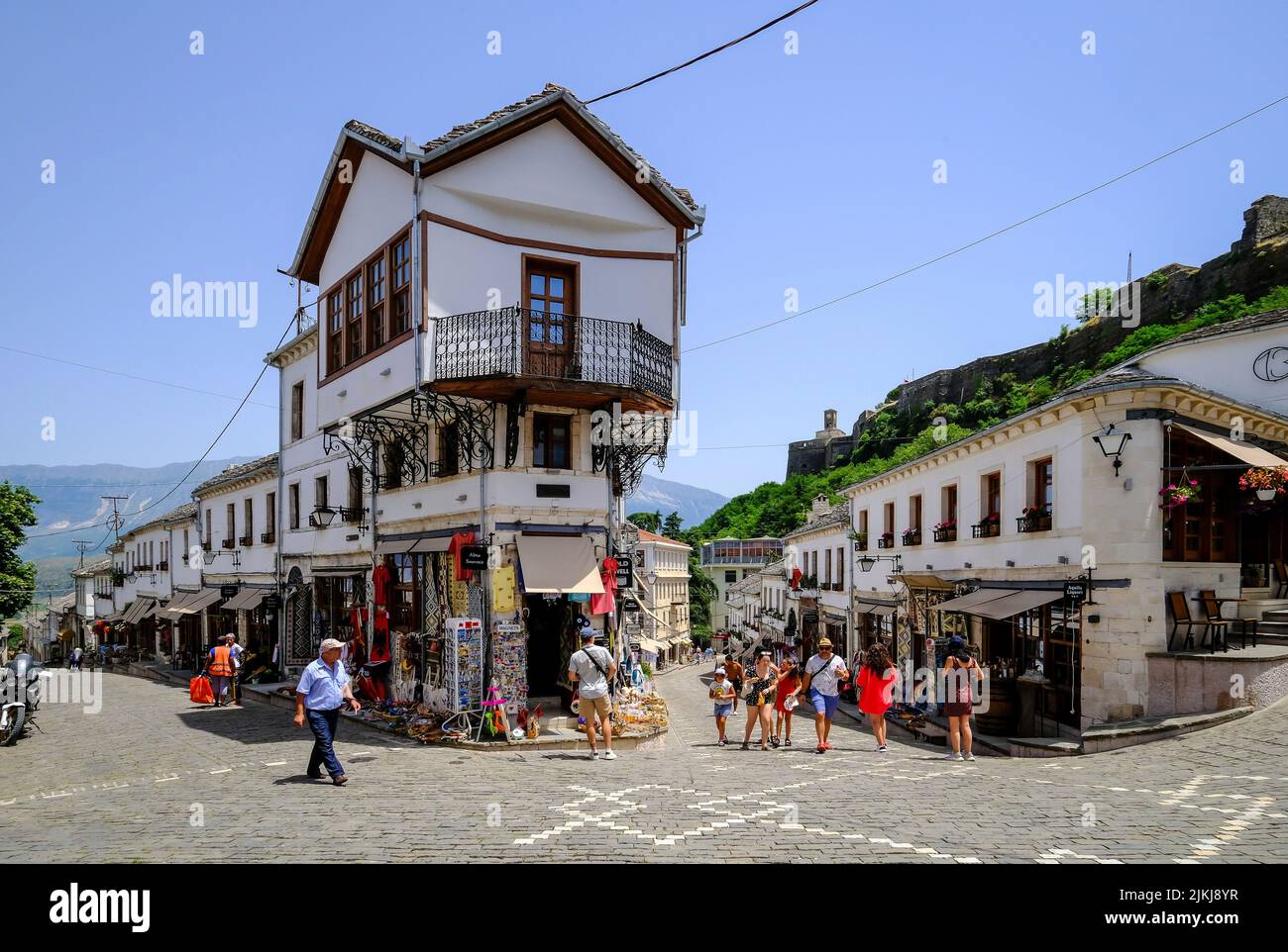 City of Gjirokastra, Gjirokastra, Albania - Tourists visit the historic old town of the mountain city of Gjirokastra, UNESCO World Heritage Site. Stock Photo
