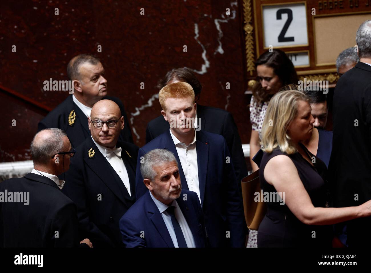 Members of parliament of French far-left opposition party La France Insoumise (France Unbowed) and the left-wing coalition NUPES, including Adrien Quatennens, come back to their seats after they left during the questions to the government session at the National Assembly in Paris, France, August 2, 2022. REUTERS/Benoit Tessier Stock Photo