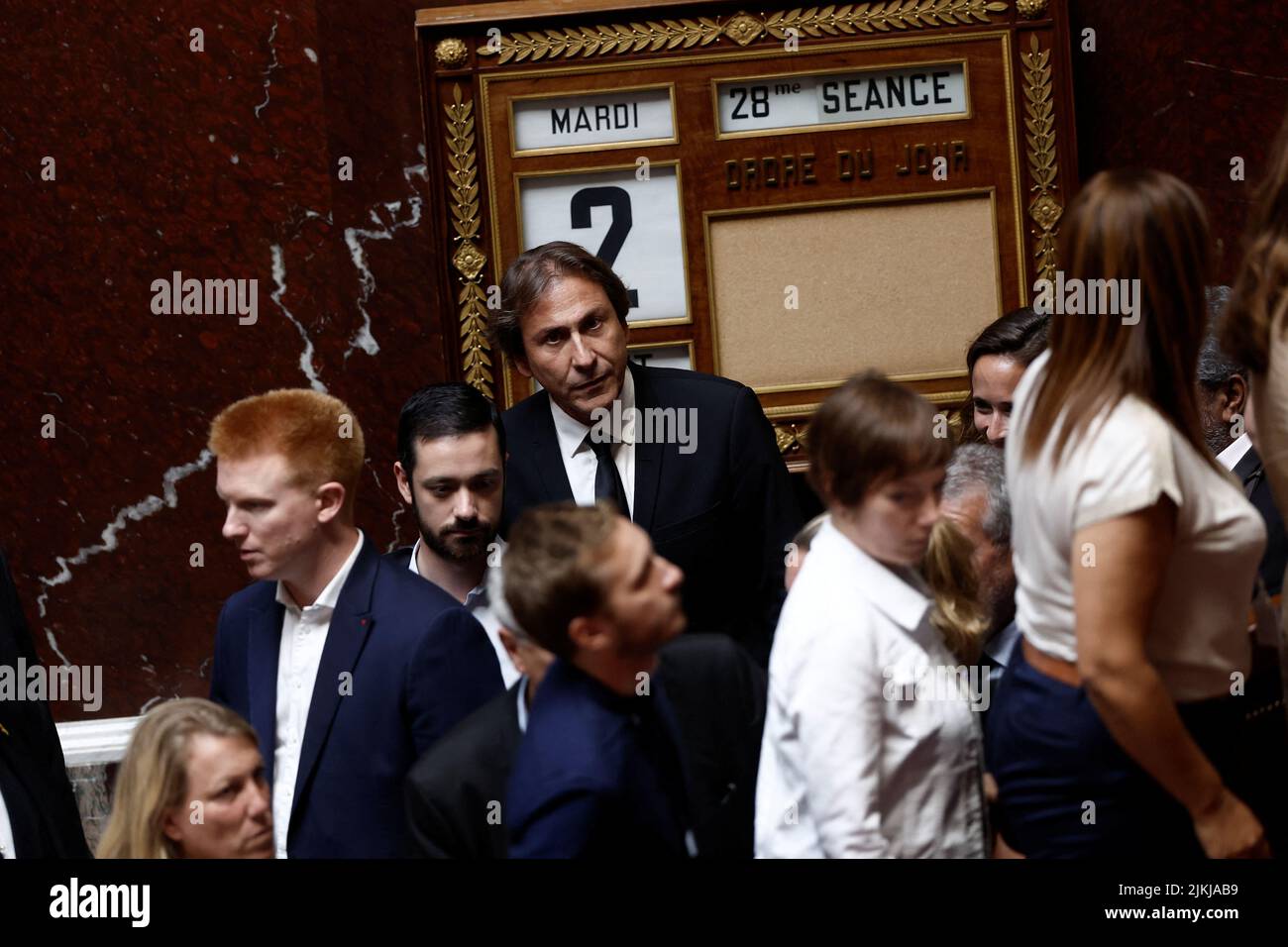 Members of parliament of French far-left opposition party La France Insoumise (France Unbowed) and the left-wing coalition NUPES, including Jerome Guedj, come back to their seats after they left during the questions to the government session at the National Assembly in Paris, France, August 2, 2022. REUTERS/Benoit Tessier Stock Photo