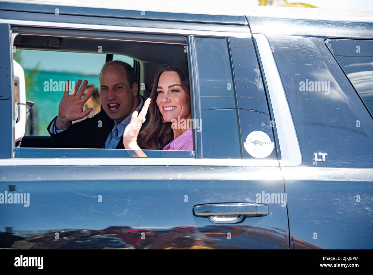 A closeup shot of Prince William and Kate greeting people from the car Stock Photo
