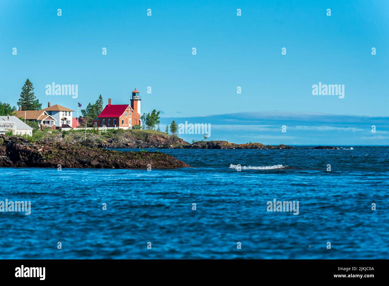 Eagle Harbor Lighthouse stands above a rocky entrance to Eagle Harbor