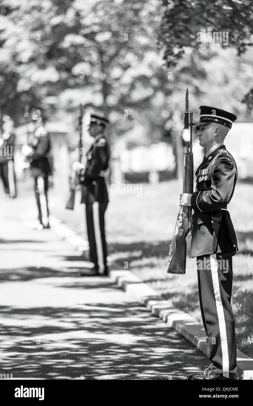 Military honor guard stand at attention at Arlington National Cemetery on Monday, May 30, 2022, as President Joe Biden and First Lady Jill Biden arrive for Memorial Day ceremonies.  (Official White House Photo by Adam Schultz) Arlington National Cemetery is a United States military cemetery in Arlington County, Virginia, across the Potomac River from Washington, D.C., in whose 639 acres the dead of the nation's conflicts have been buried, beginning with the Civil War, as well as reinterred dead from earlier wars. The United States Department of the Army, a component of the United States Dept. Stock Photo