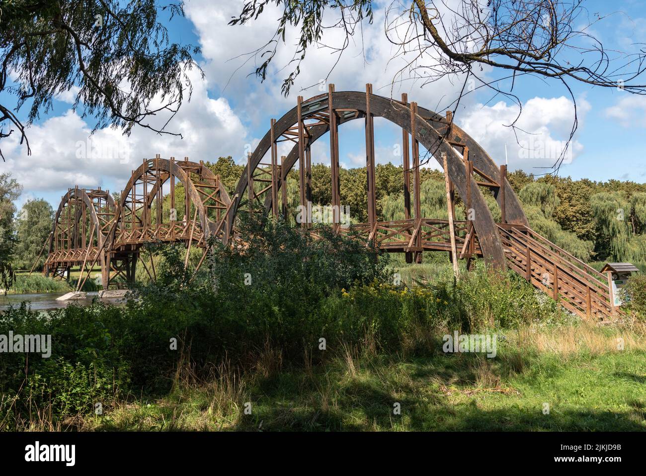 A rustic metal arch bridge over the river in the forest Stock Photo - Alamy