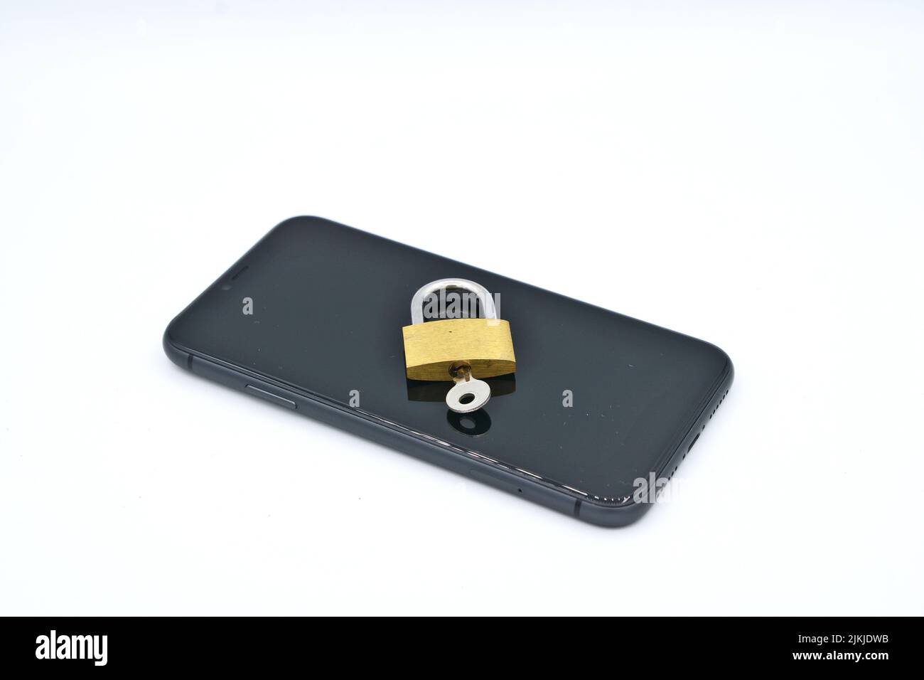 A padlock with a key on a phone- cybersecurity concept Stock Photo