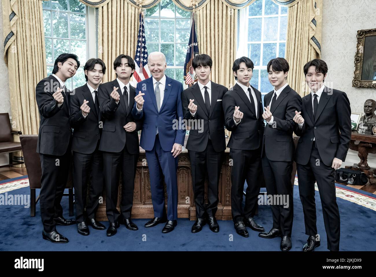 President Joe Biden records a digital video with the K-pop singing group BTS on Tuesday, May 31, 2022, in the Oval Office of the White House.  (Official White House Photo by Adam Schultz) Stock Photo