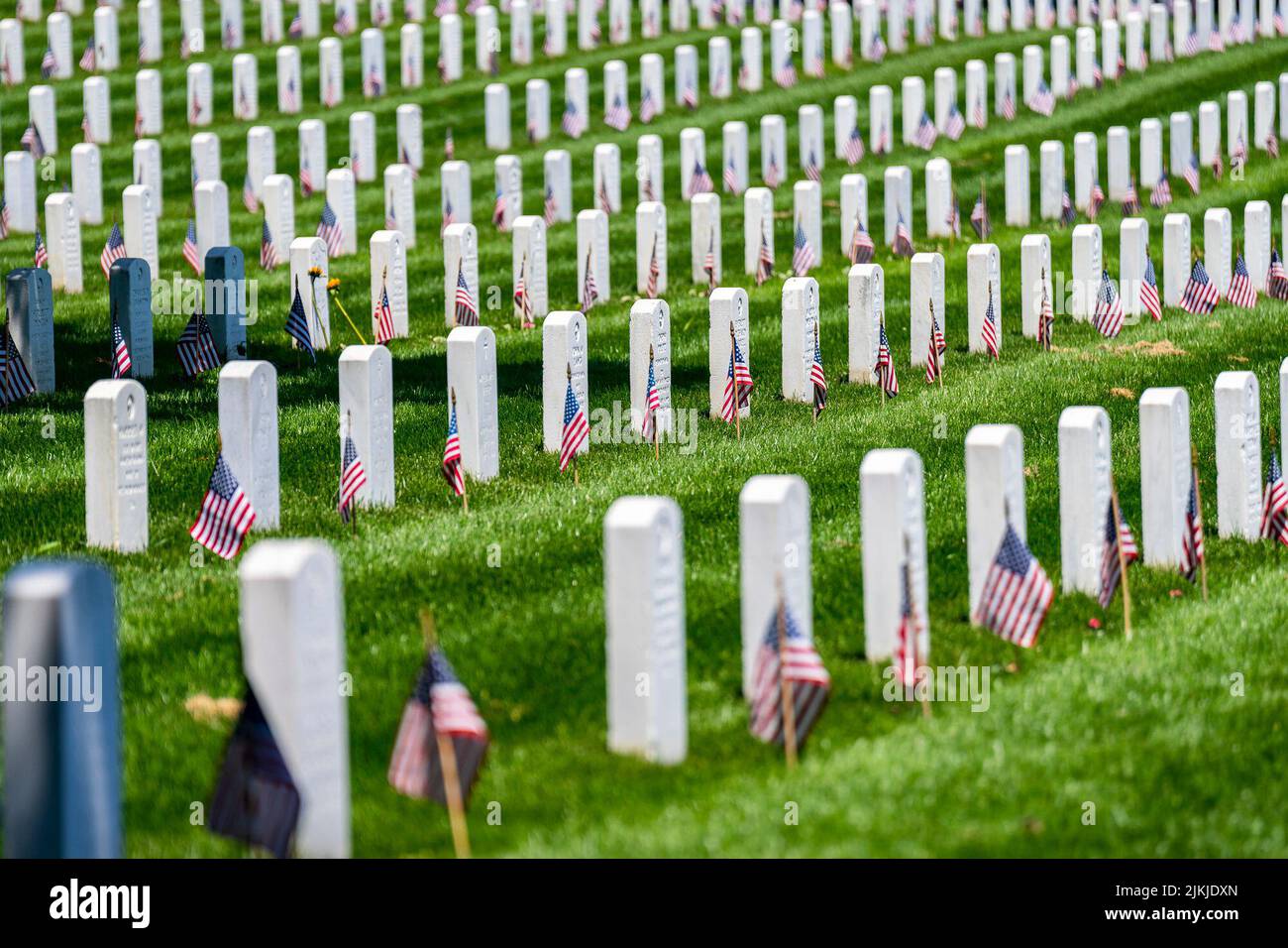 American flags line Arlington National Cemetery on Monday, May 30, 2022, as President Joe Biden and First Lady Jill Biden arrive for Memorial Day ceremonies.  (Official White House Photo by Adam Schultz) Arlington National Cemetery is a United States military cemetery in Arlington County, Virginia, across the Potomac River from Washington, D.C., in whose 639 acres the dead of the nation's conflicts have been buried, beginning with the Civil War, as well as reinterred dead from earlier wars. The United States Department of the Army, a component of the United States Department of Defense (DoD), Stock Photo