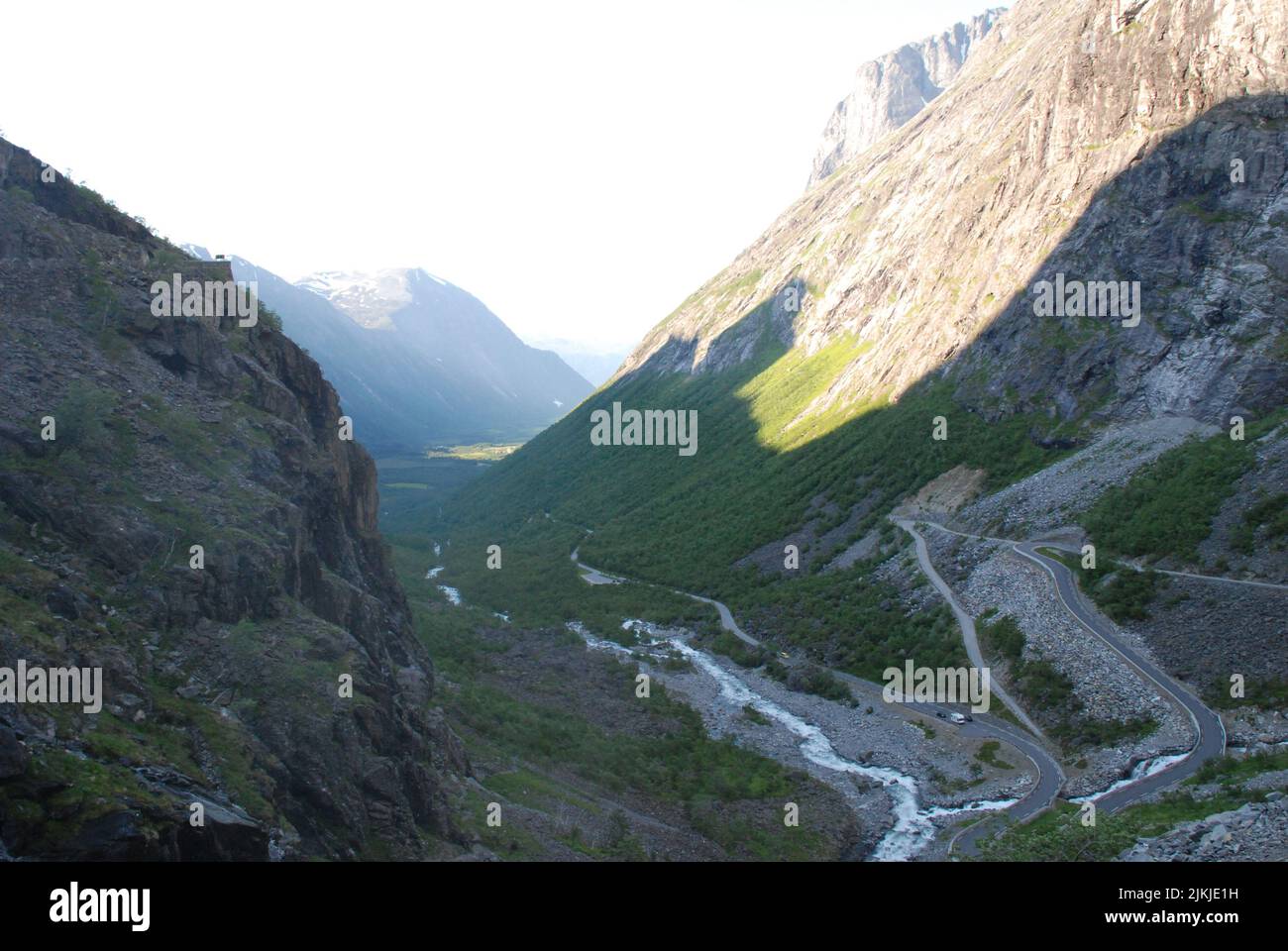 A scenic view of the river along rocky mountains under sunlight Stock ...