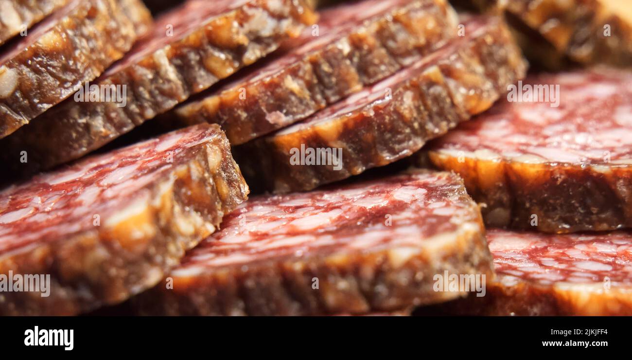 Delicious smoked sausage. Meat products. Close-up. Sausage full frame. Stock Photo