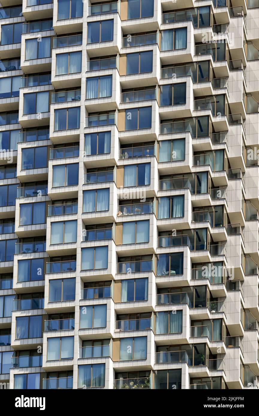 London, England - June 2022: Close-up view of the exterior of a tall block of apartments in Canary Wharf. Stock Photo