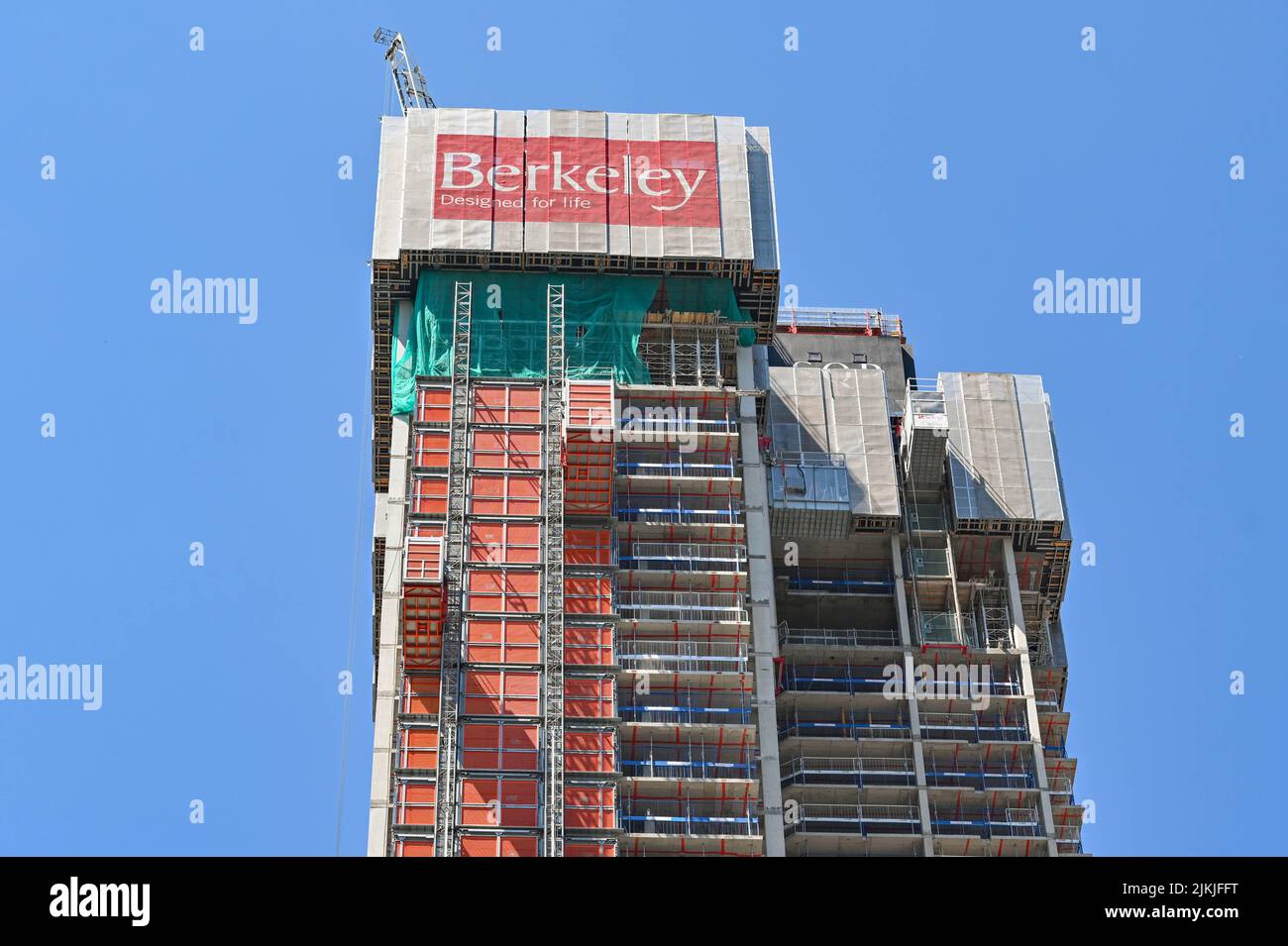 London, England - June 2022: Exterior view of a new block of apartments being built in Canary Wharf. The developer is Berkley Homes. Stock Photo