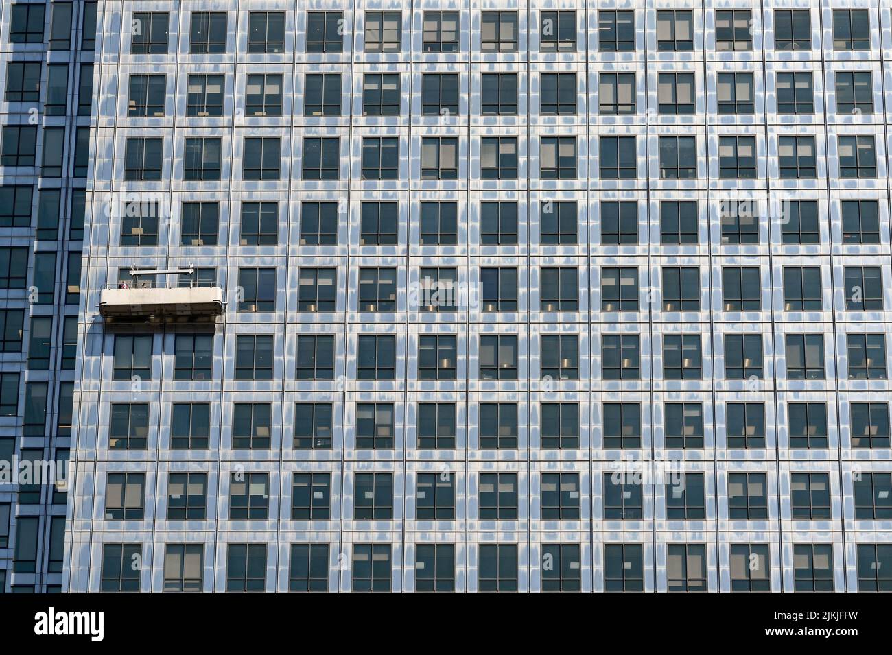 London, England - June 2022: Window cleaning cradle on the outside of an office tower block in anary Wharf Stock Photo