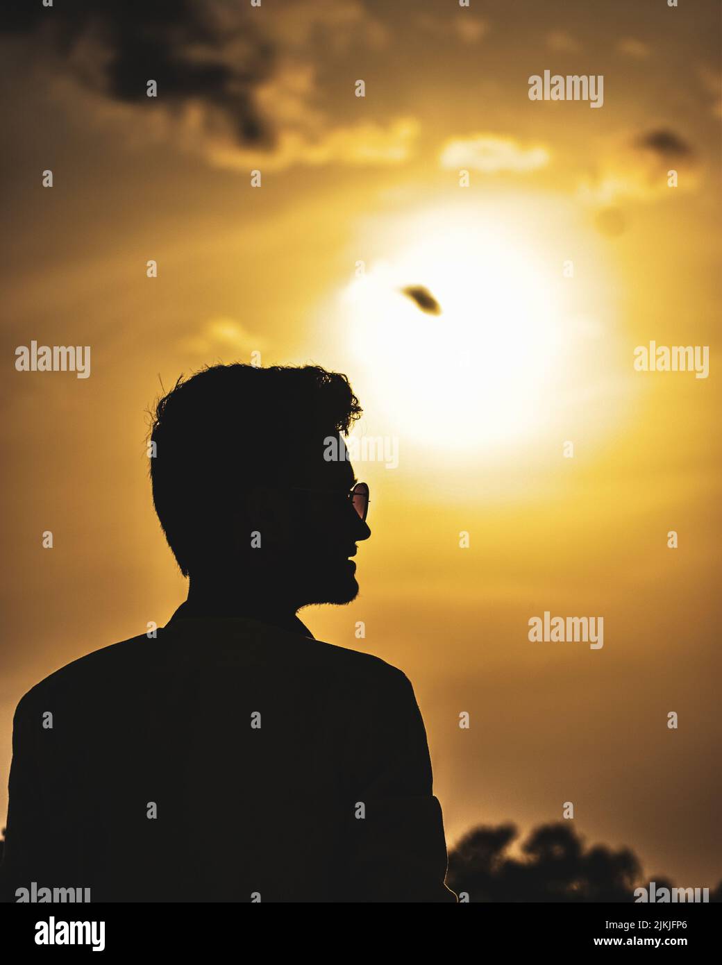 A silhouette of male against a beautiful sunset background Stock Photo