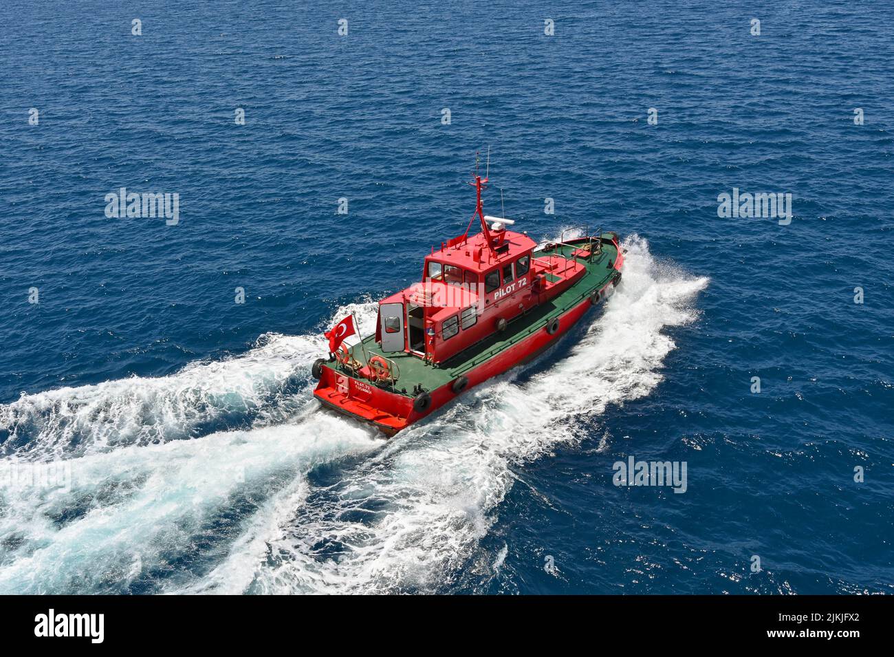 Kusadasi, Turkey - May 2022: Aerial view of a pilot boat leaving a cruise ship after guiding it out of port Stock Photo