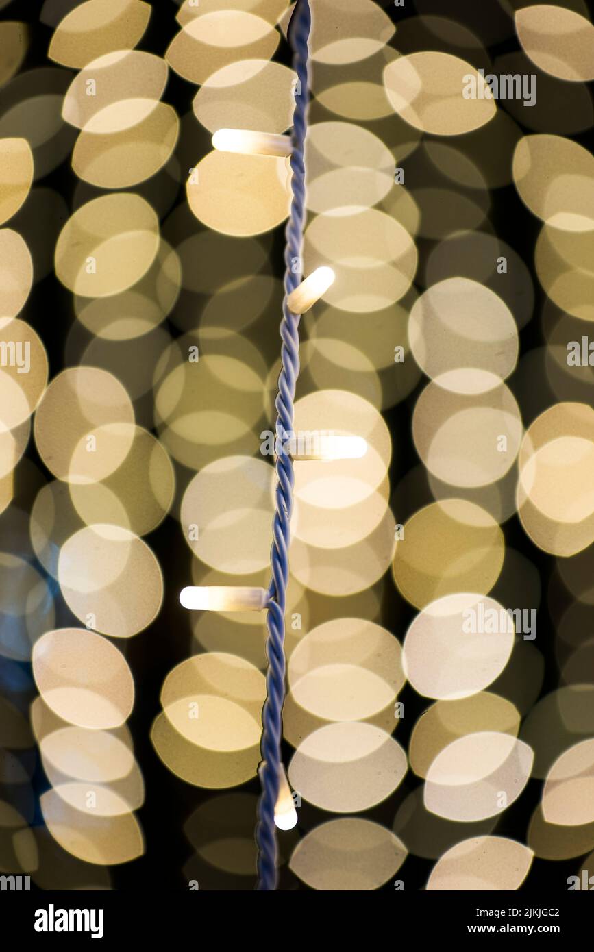 The Christmas lights with vivid yellow bokeh lights in the background Stock Photo