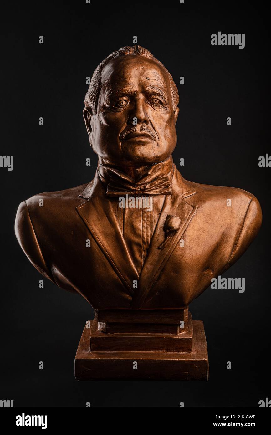 A vertical shot of a statue of Don Corleone from the Godfater Stock Photo