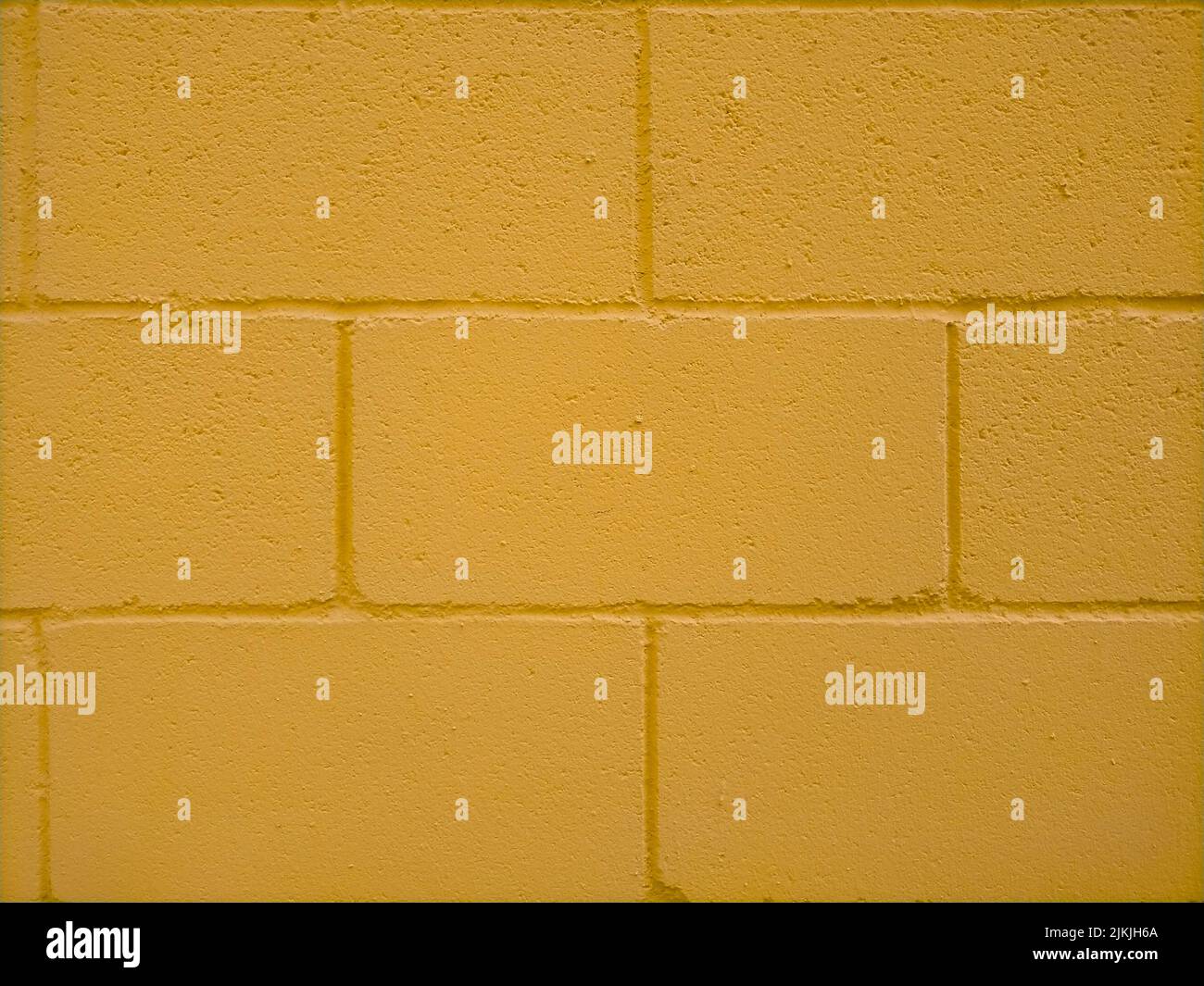A yellow painted brick wall texture Stock Photo