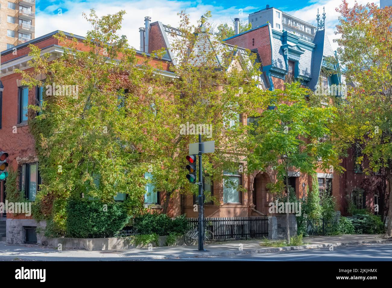 The beautiful building facade surrounded by green vegetation. Montreal, Canada. Stock Photo