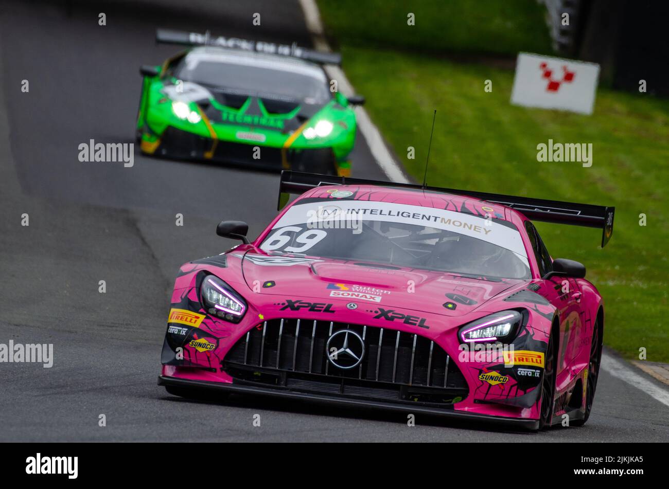 A low angle shot of a Mercedes-AMG GT3 pink car during the race in the British GT Championship, Stock Photo