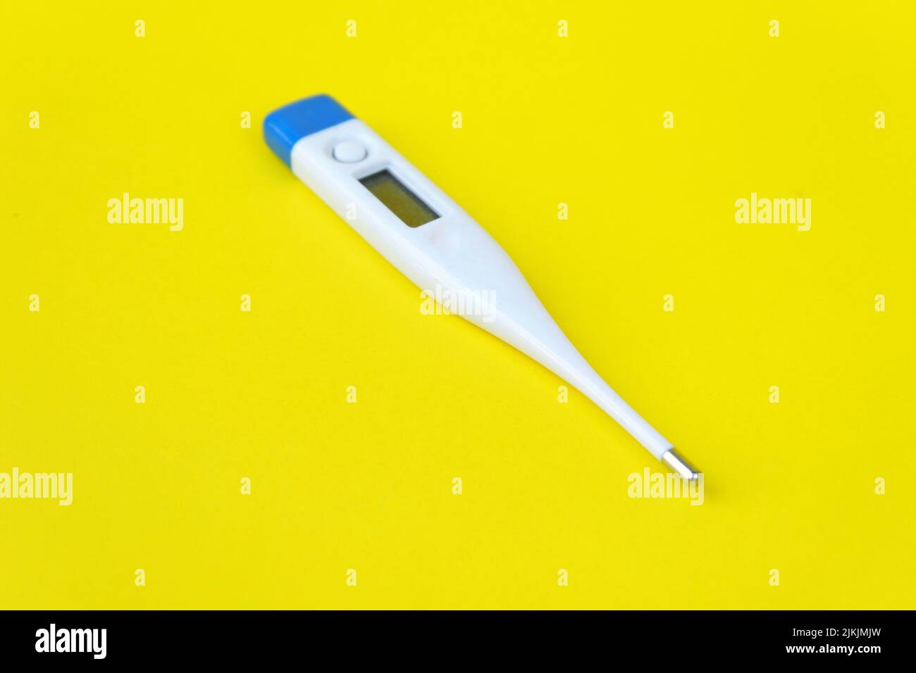 thermometer isolated on yellow background Stock Photo
