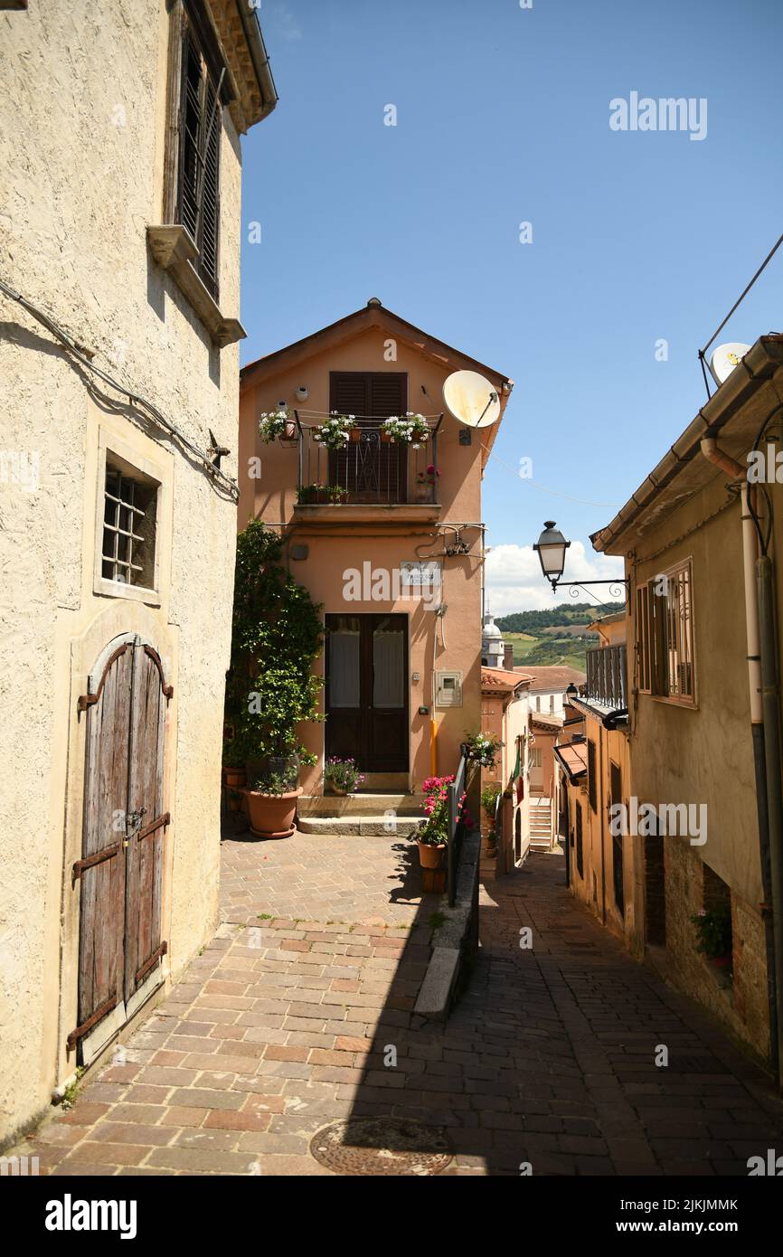 A vertical shot of an old narrow street with houses in the village of San Fele in the Basilicata region, Italy. Stock Photo