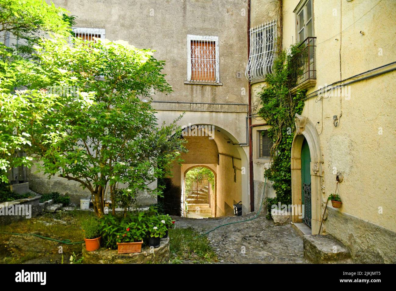A beautiful small square with trees and old houses in the village of San Fele in the Basilicata region, Italy. Stock Photo