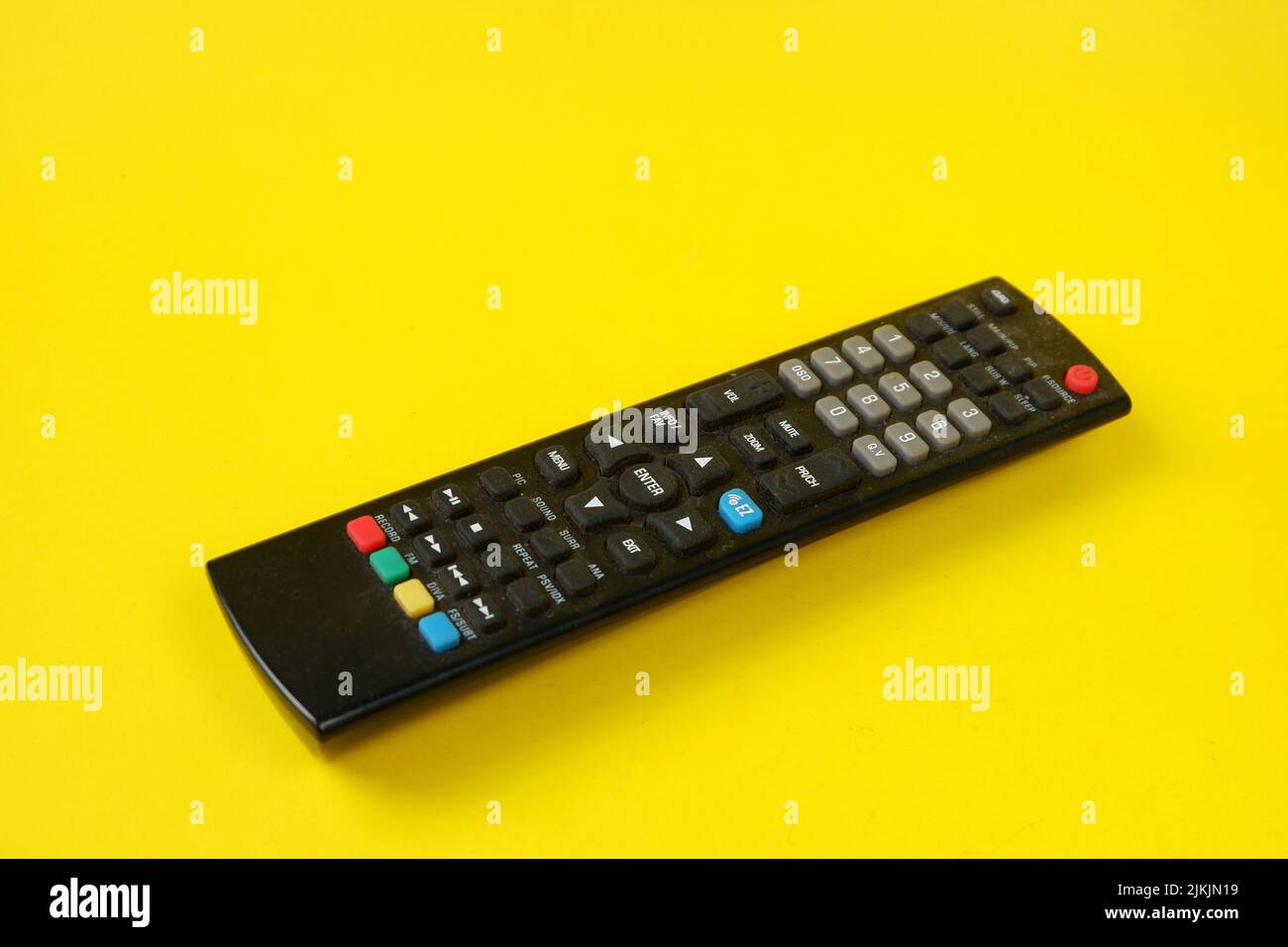 tv remote isolated on yellow background Stock Photo