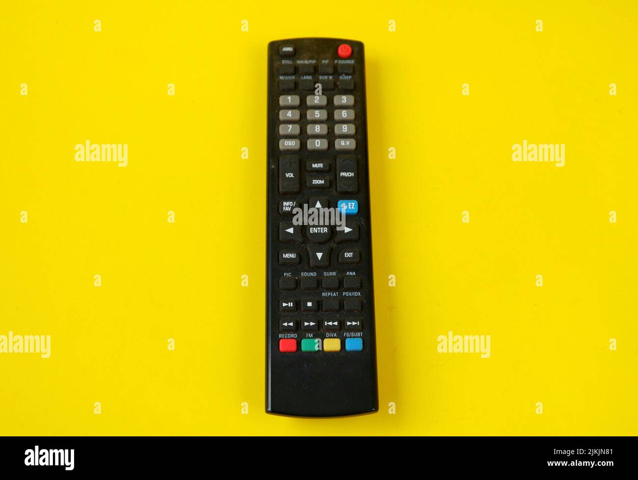 tv remote isolated on yellow background Stock Photo