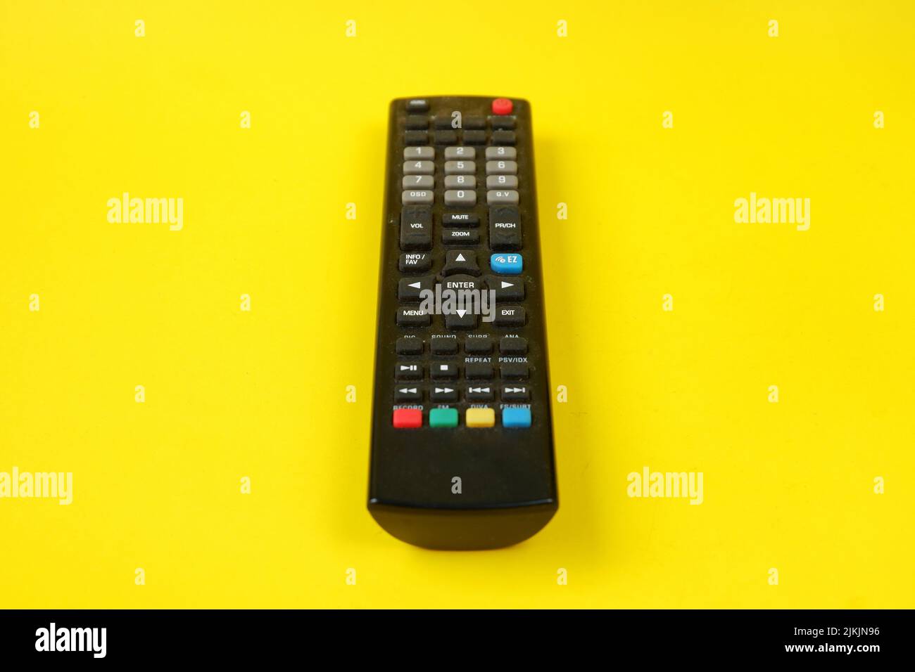 tv remote isolated on yellow background Stock Photo