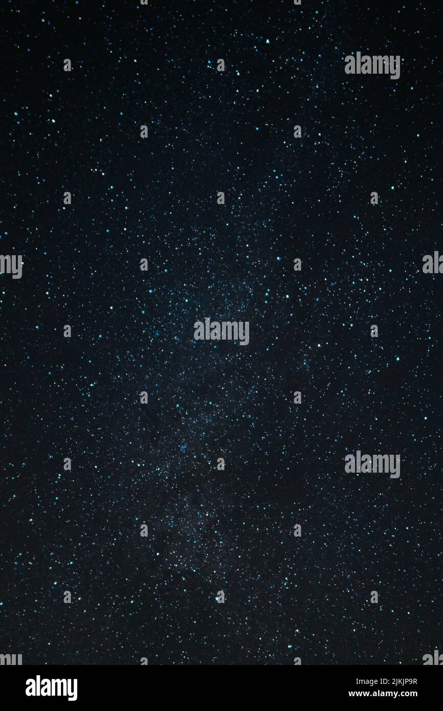 A vertical shot of the dark black sky with stars and milkyway at ...