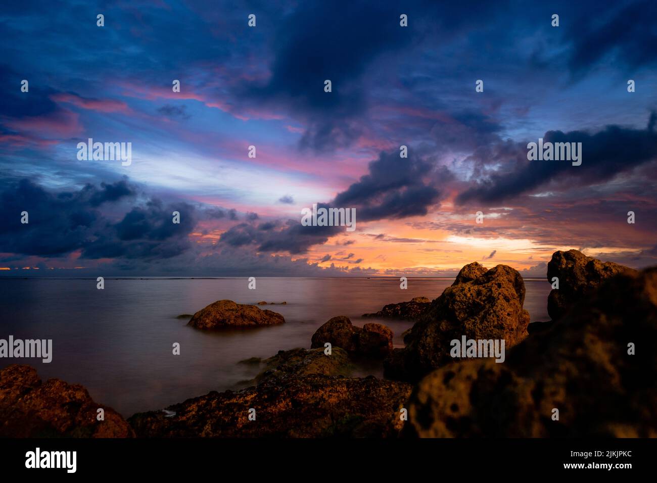 A beautiful view of sea with huge rocks at scenic sunset Stock Photo ...
