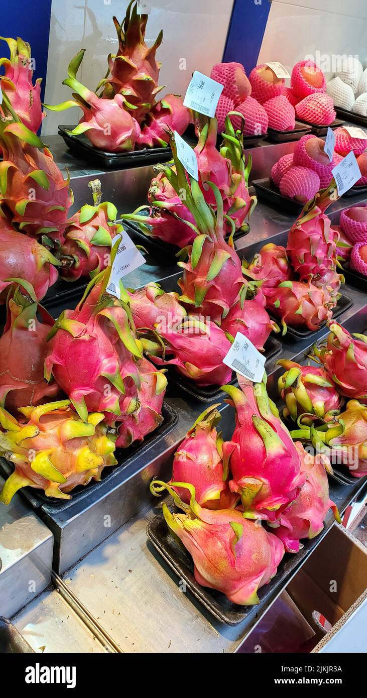 The vertical closeup of the dragon fruit display in a market. Hong kong