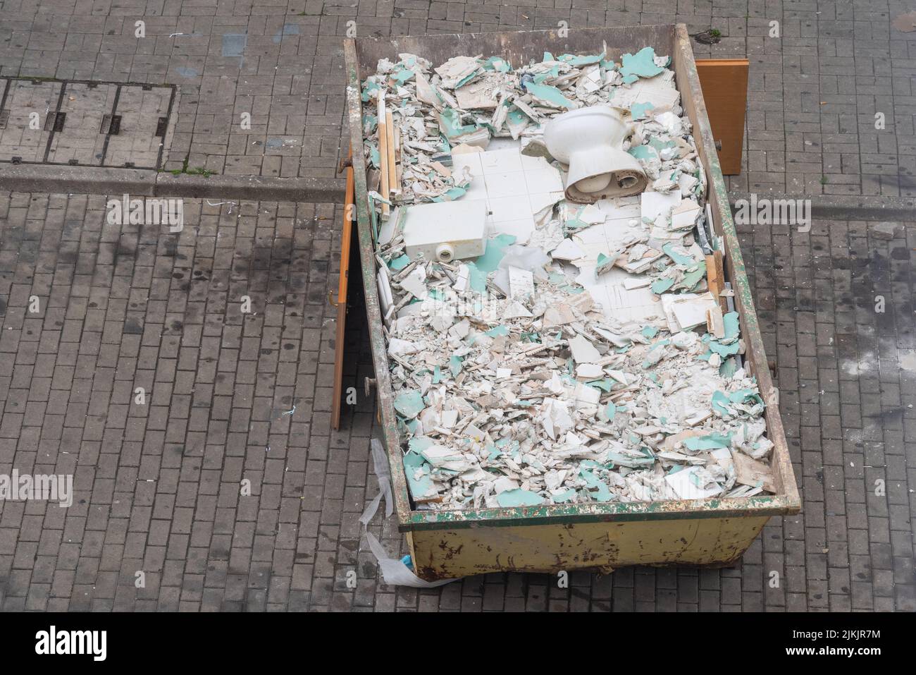 A shot of broken white tiles on a rubble container Stock Photo
