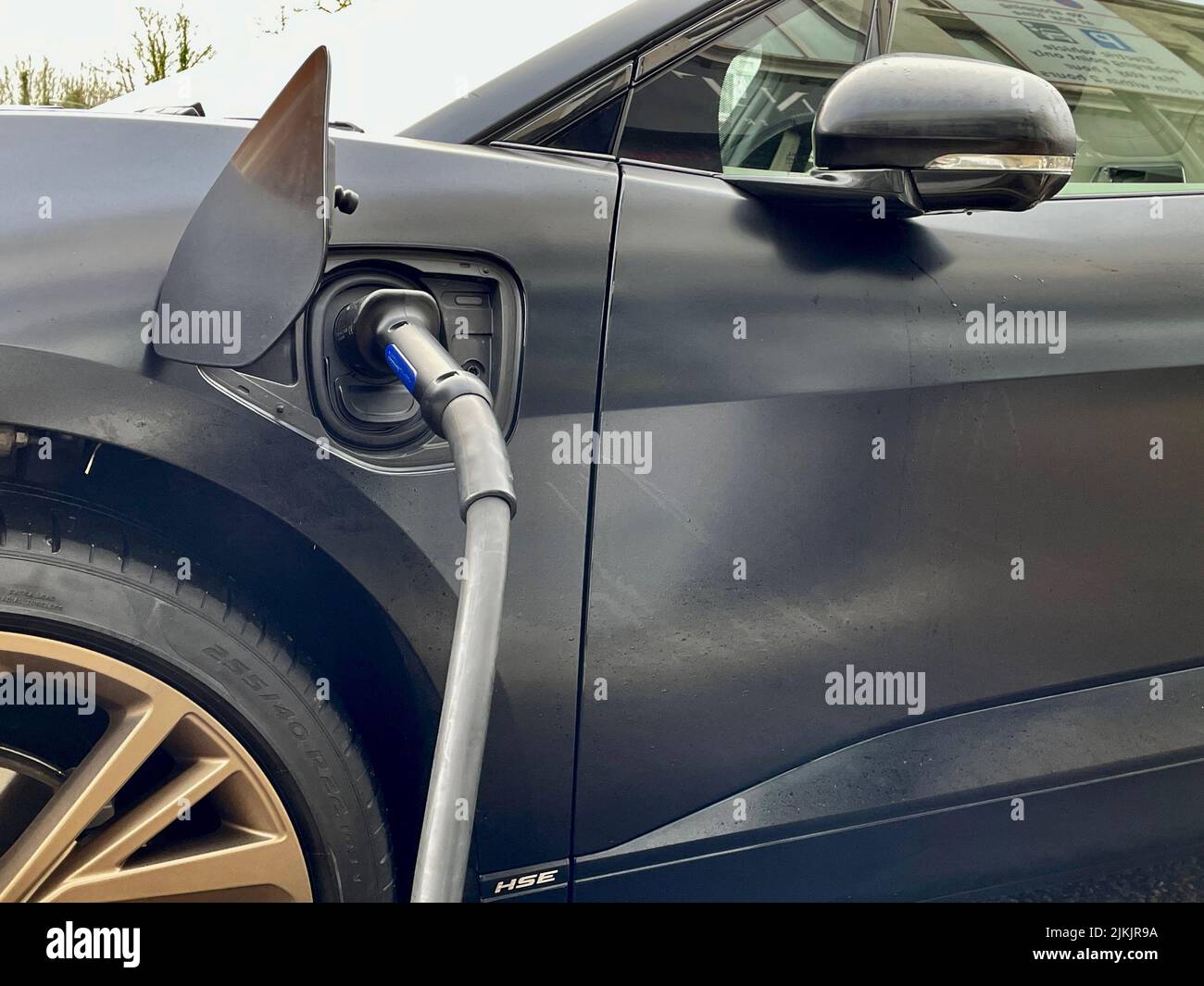 Black Jaguar electric car charging Stock Photo Alamy