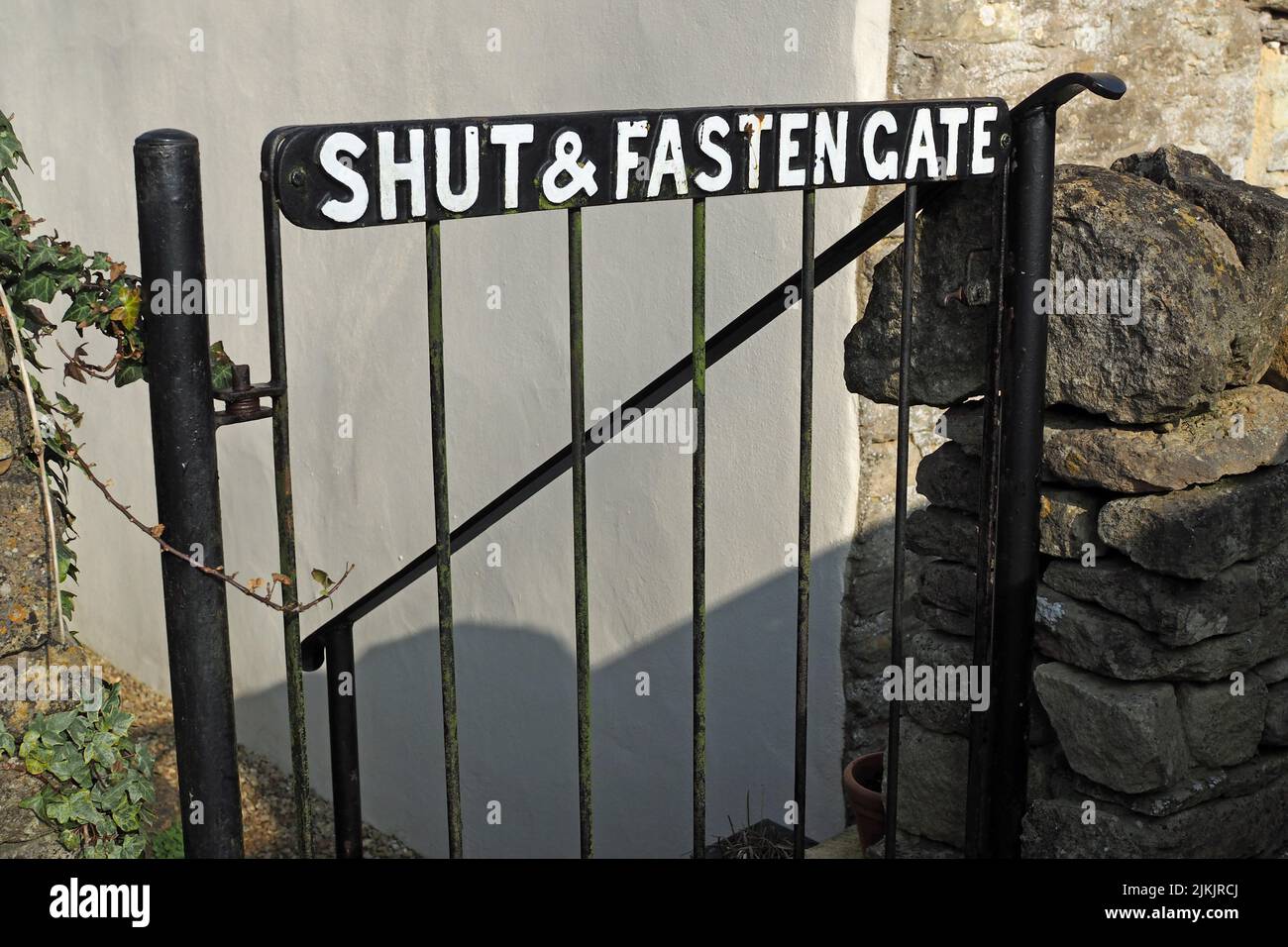 Metal gate with Shut and Fasten Gate text Stock Photo