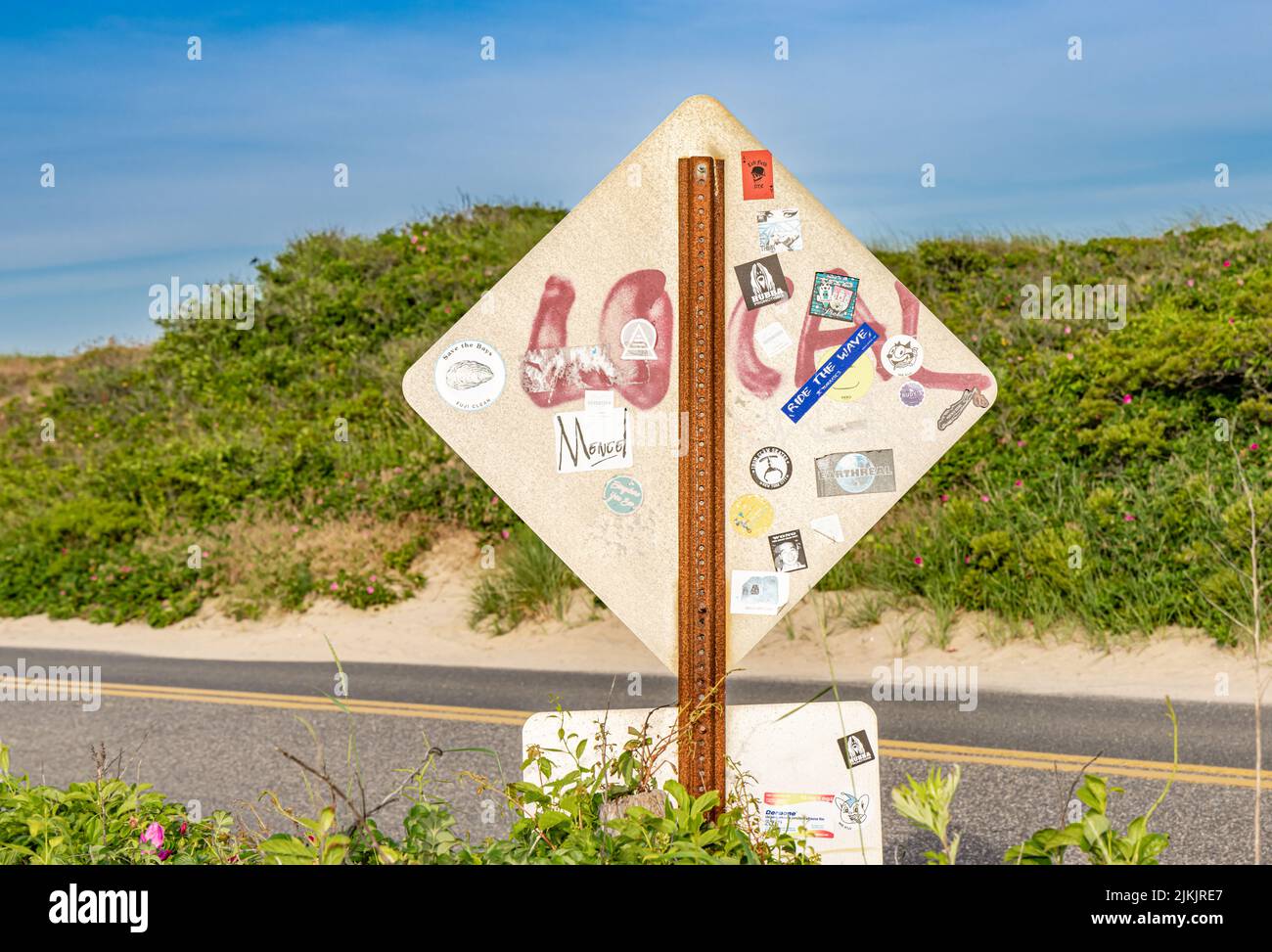 Back of a traffic sign that has been vandalized Stock Photo