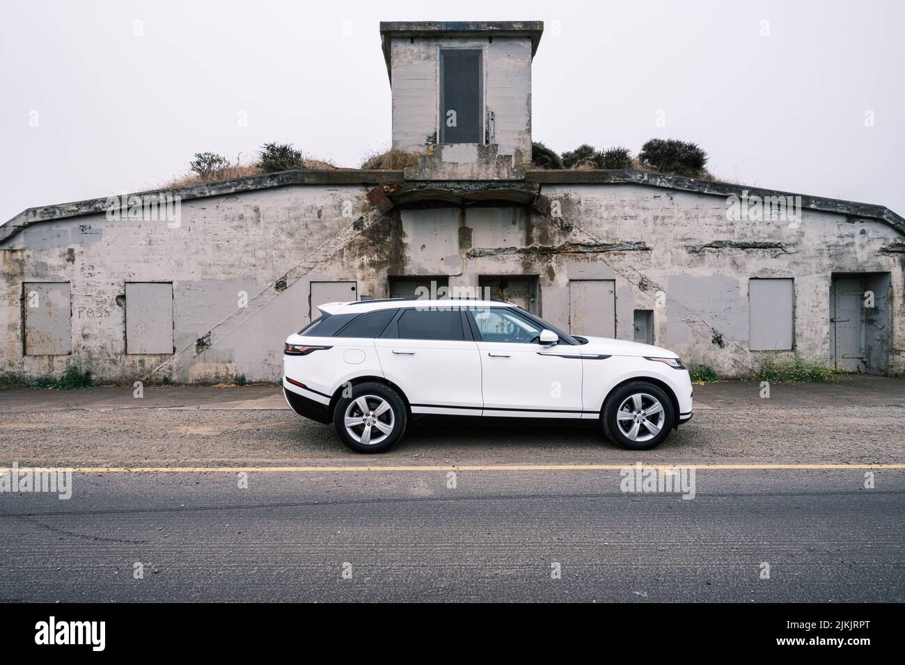 White automobile set against historic battery on Conzelman road in San Francisco. Stock Photo