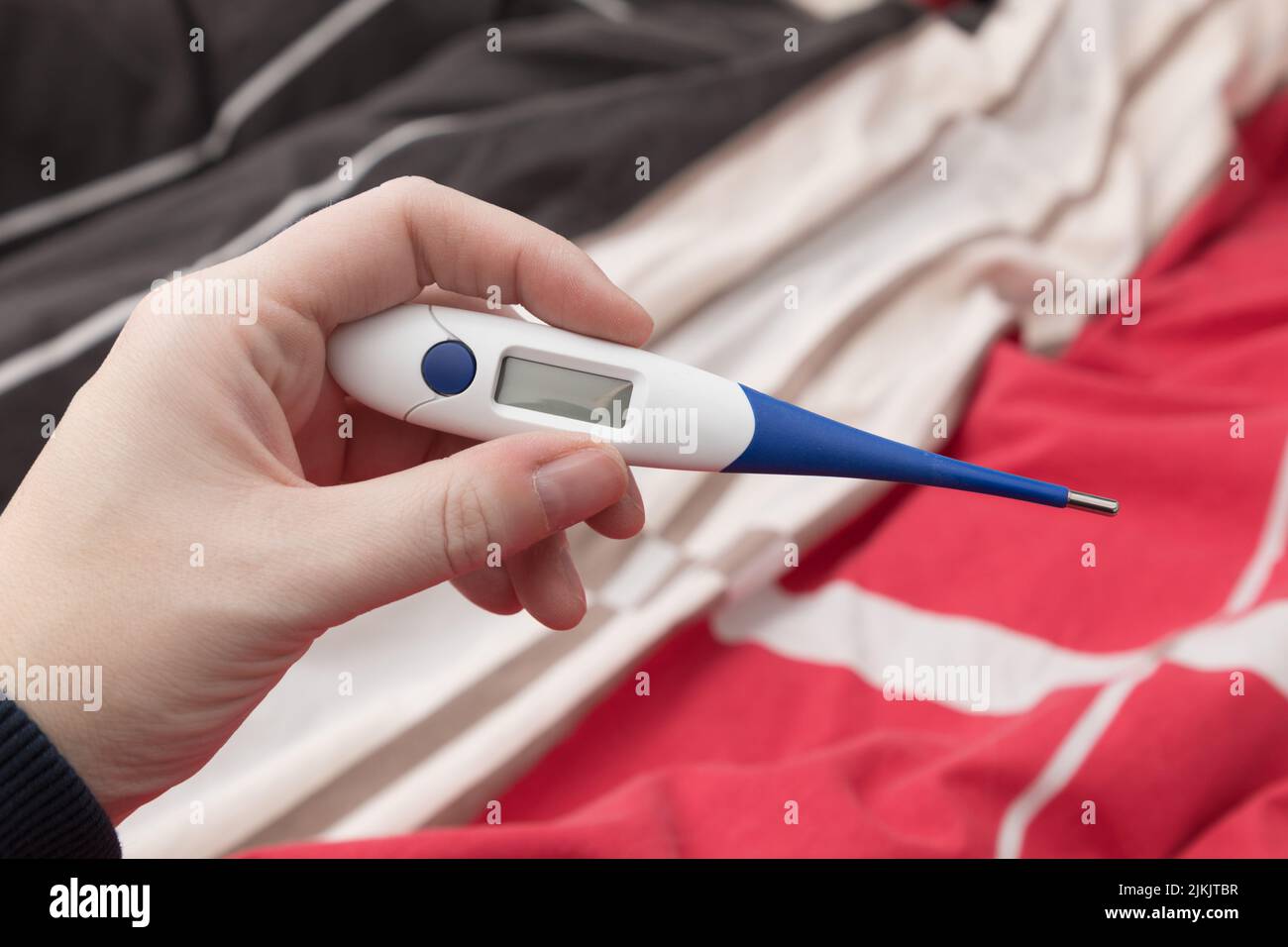 A closeup of a person holding a thermometer Stock Photo Alamy