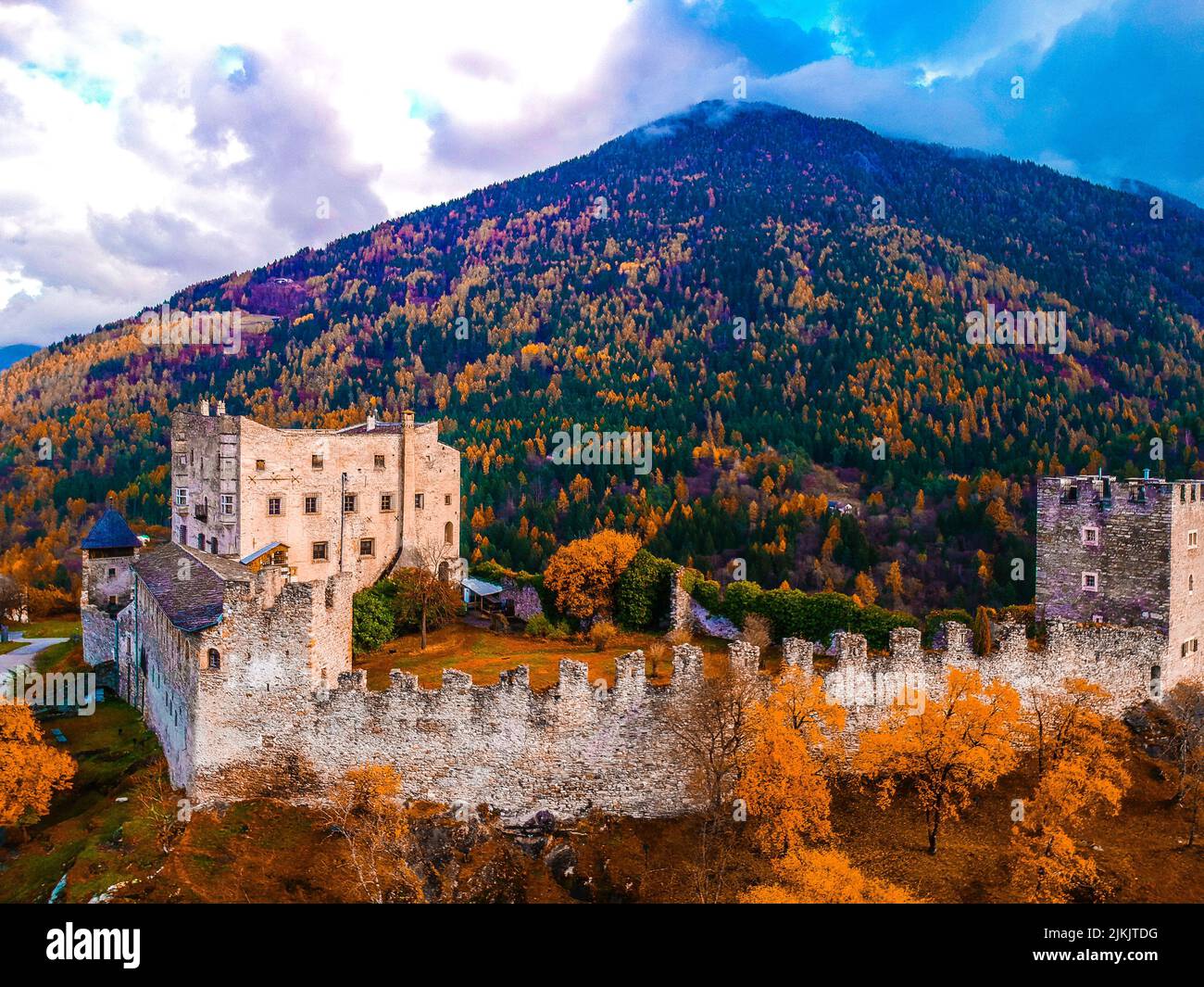 A beautiful view of the castle on the forested mountain Stock Photo