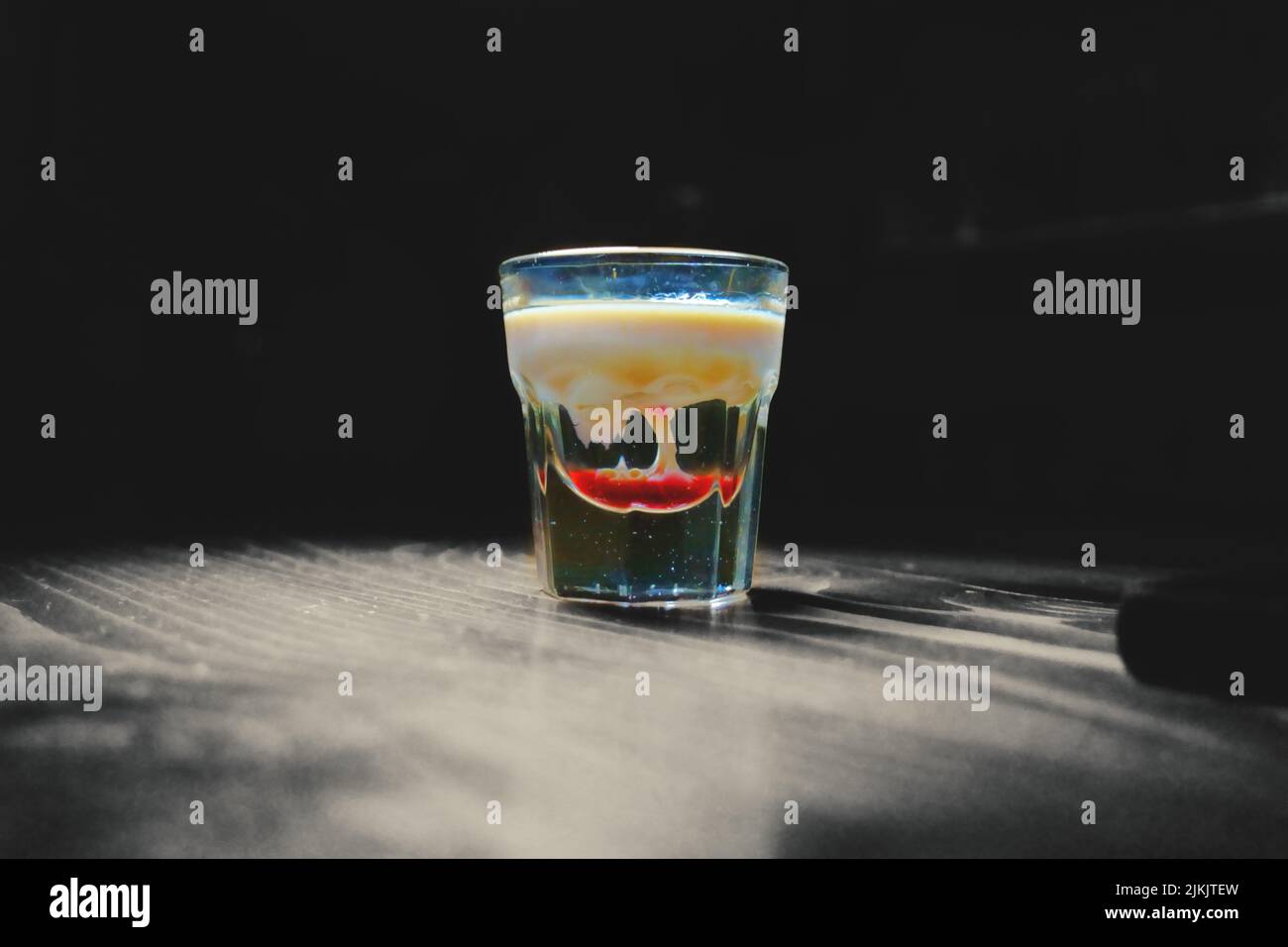 A alien brain shot.Tornado in shot alcohol drink based on cream, liqueur and grenadine with baileys Stock Photo