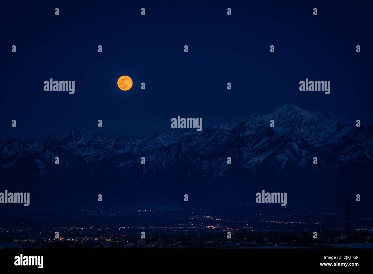 A beautiful view of the Wasatch mountain range against the shiny moon Stock Photo