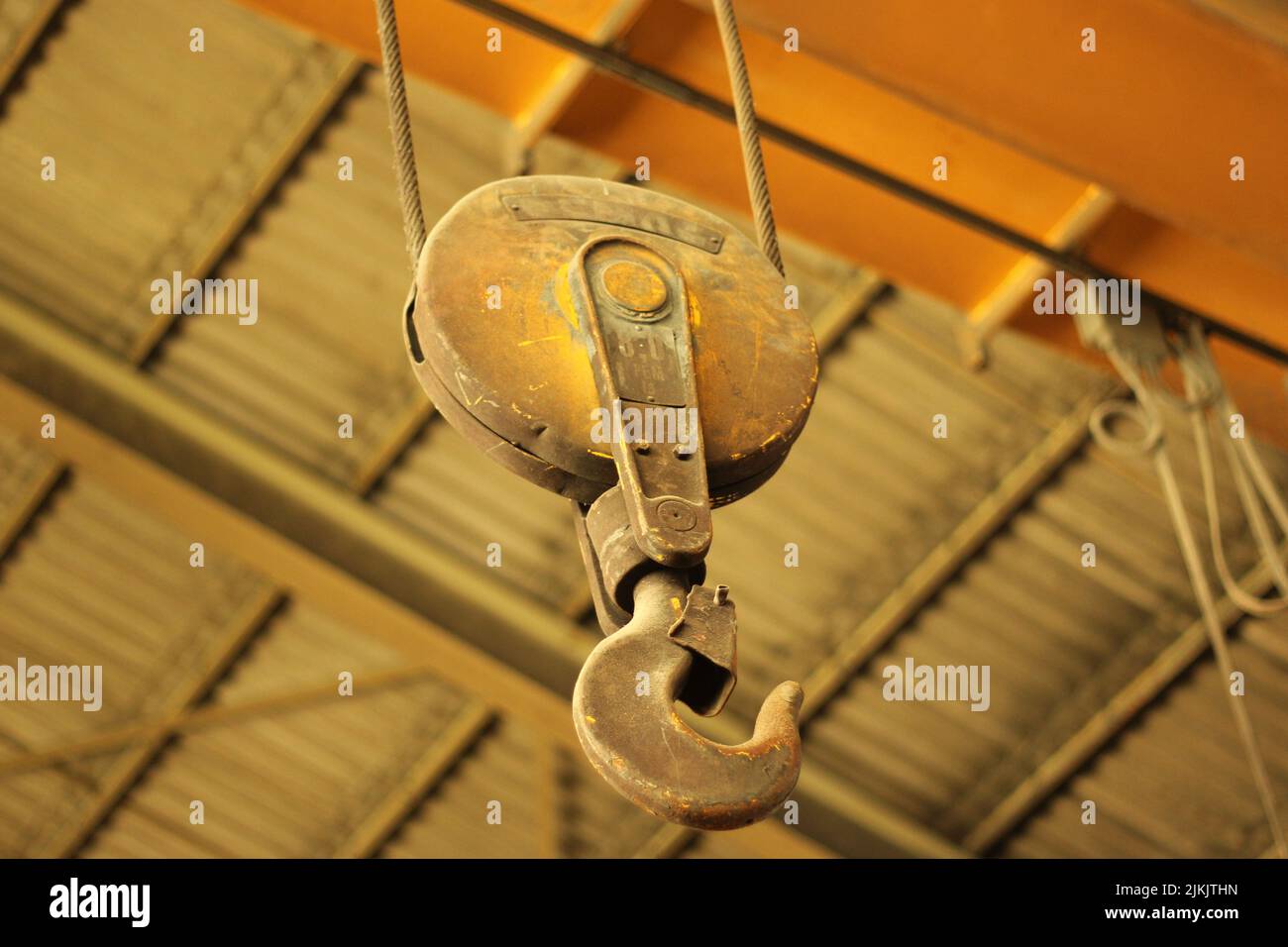 A selective focus shot of an iron hook hanging from a ceiling Stock Photo