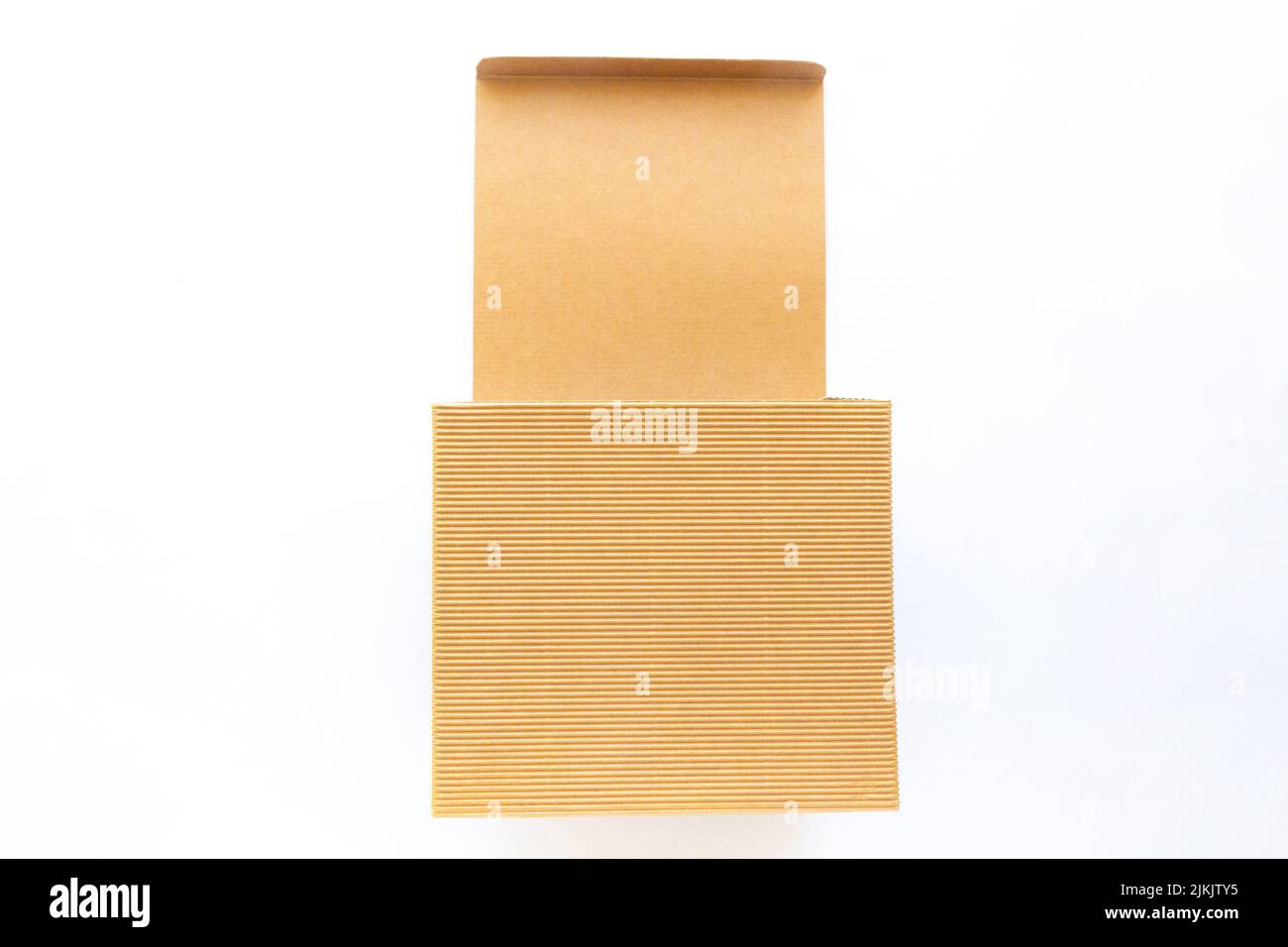 An open brown corrugated kraft cardboard box isolated on white background. Stock Photo