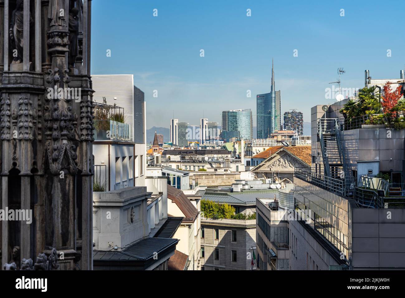 Milan financial district skyline with the Alps in the background, seen from Milan Cathedral roof, Italy Stock Photo