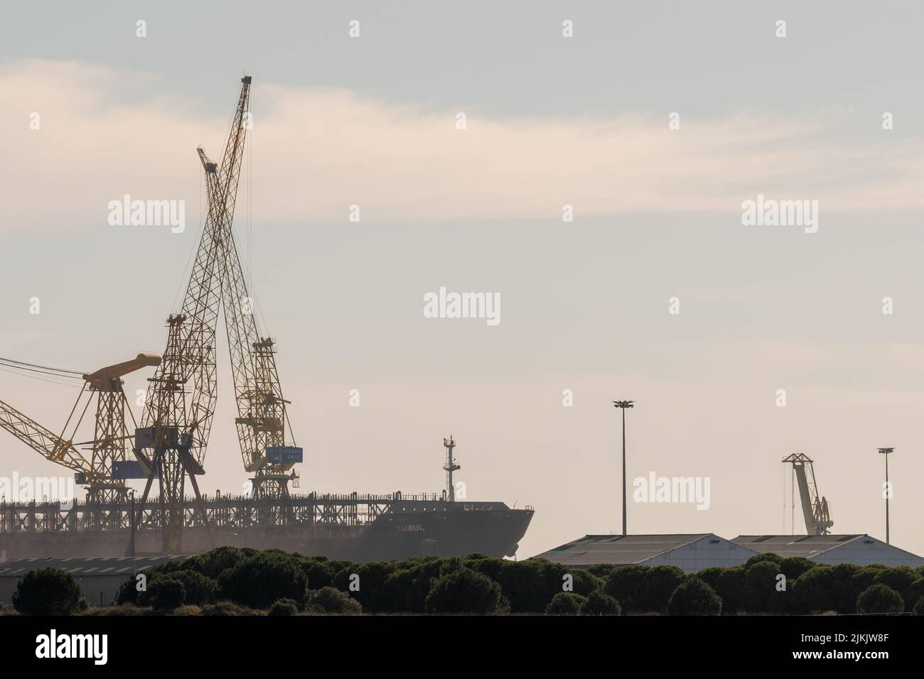Two cranes used for lifting and moving heavy loads and materials in ...