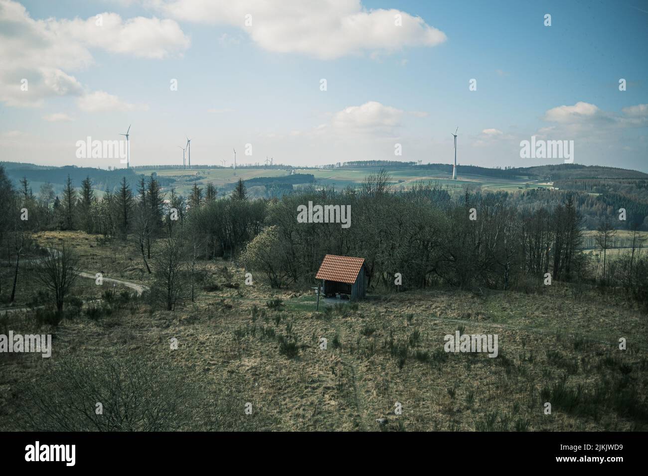 A beautiful landscape of a rural area with a small wooden cabin in the ...