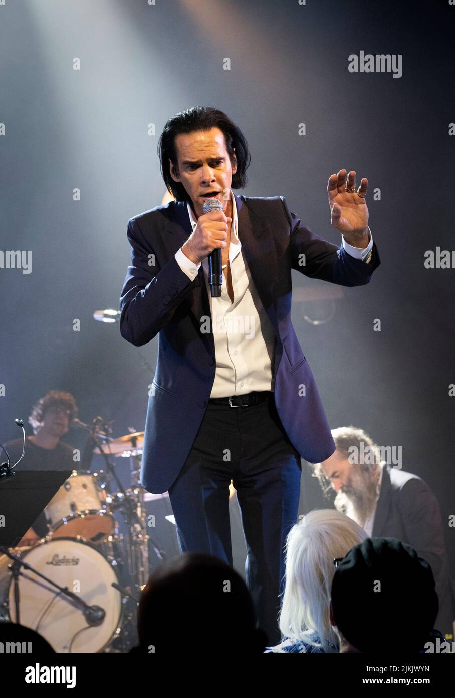 A vertical shot of Nick Cave and Warren Ellis performing at the Paramount theater in Oakland, California, United States Stock Photo
