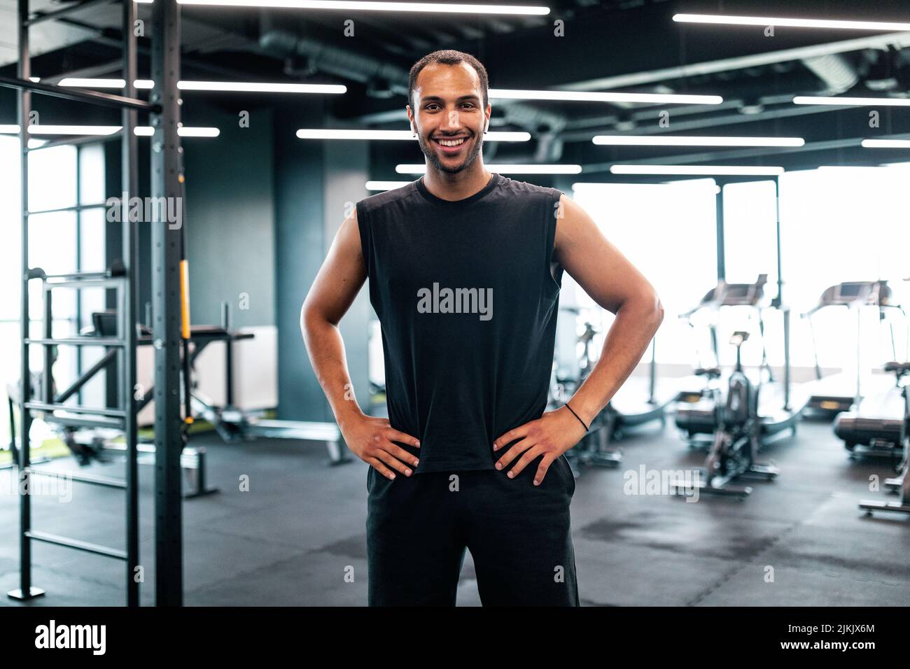 Portrait Of Handsome Black Personal Trainer Posing In Fitness Club