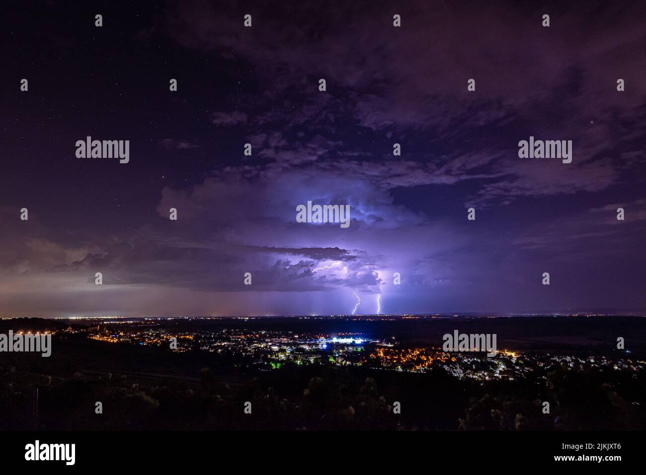 A thunderstorm in the purple sky over Frankfurt Rhine-Main, Germany Stock Photo