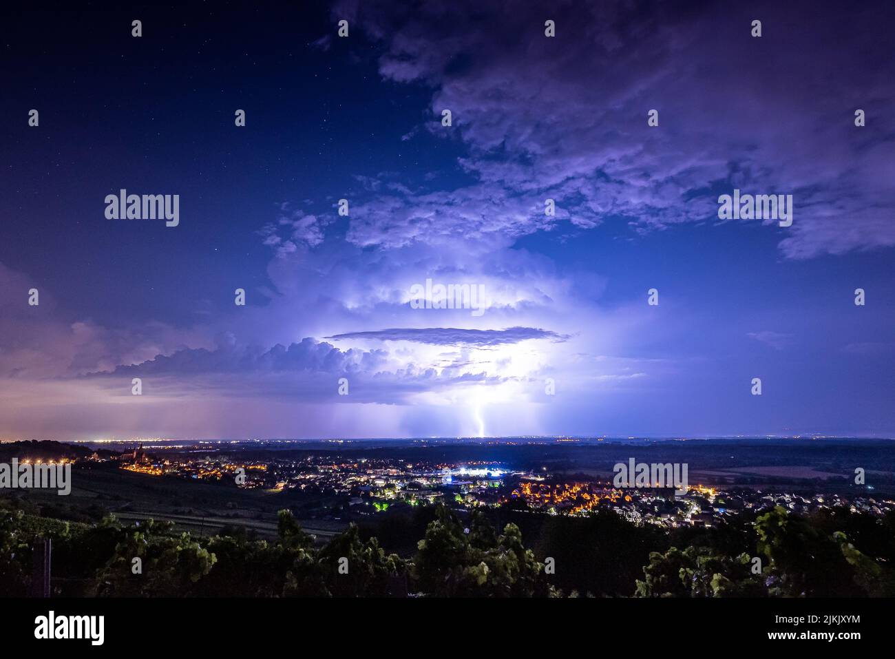 A thunderstorm in the purple sky over Frankfurt Rhine-Main, Germany Stock Photo