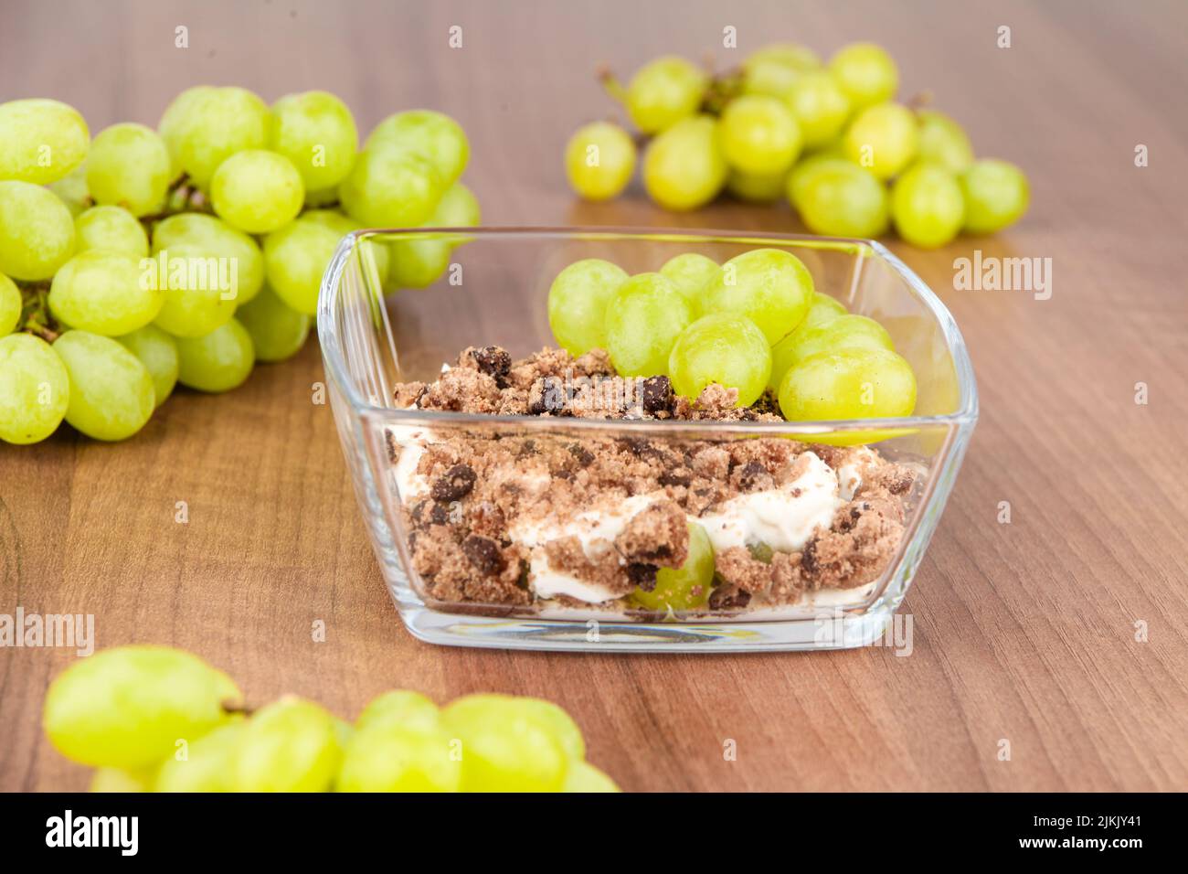 mascarpone cream dessert with grapes and cookies Stock Photo